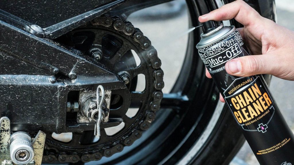 Man Lubricating and Cleaning the motorcycle chain