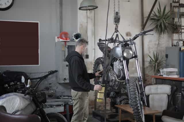 Mechanic Servicing motorcycle for better fuel economy