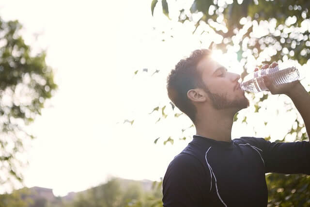 Rider drinking water to keep himself hydrated during long motorcycle ride