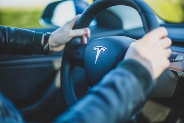 man driving a tesla