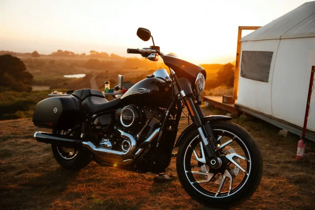 harley davidson standing outside the camp in a mountain