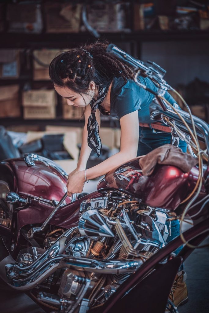 a women mechanic repairing a bike
