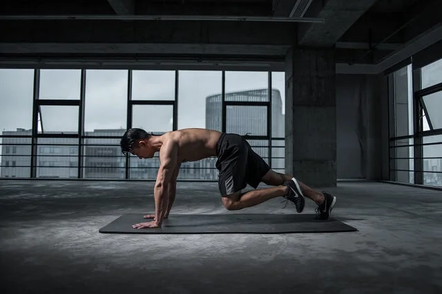 Man doing exercise to get physically prepared for long motorcycle ride